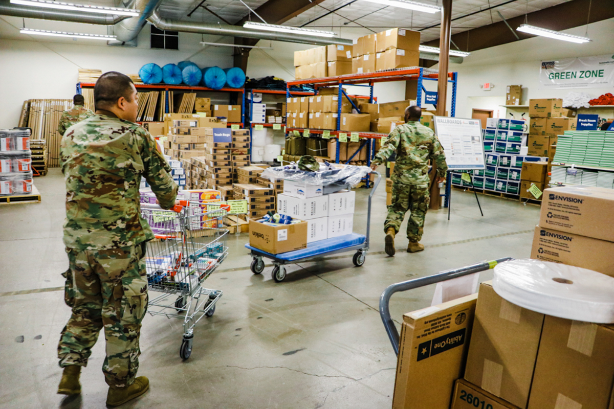 Two soldiers shopping with carts at the North Fort BSC in Fort Lewis