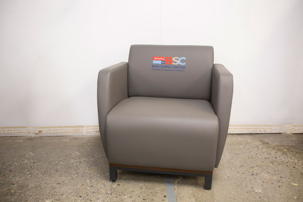 A grey arm chair sitting in a room.